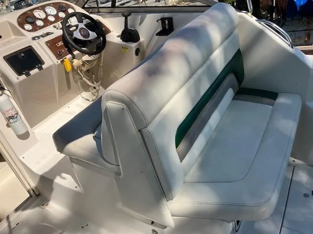 Slide: The Image of 1997 Donzi 27 LXC boat interior with white and green seating, steering wheel, and dashboard. - 6