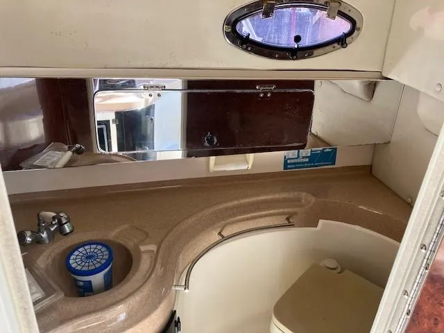 Slide: The Image of 1997 Donzi 27 LXC boat interior bathroom with sink, mirror, and toilet. - 7