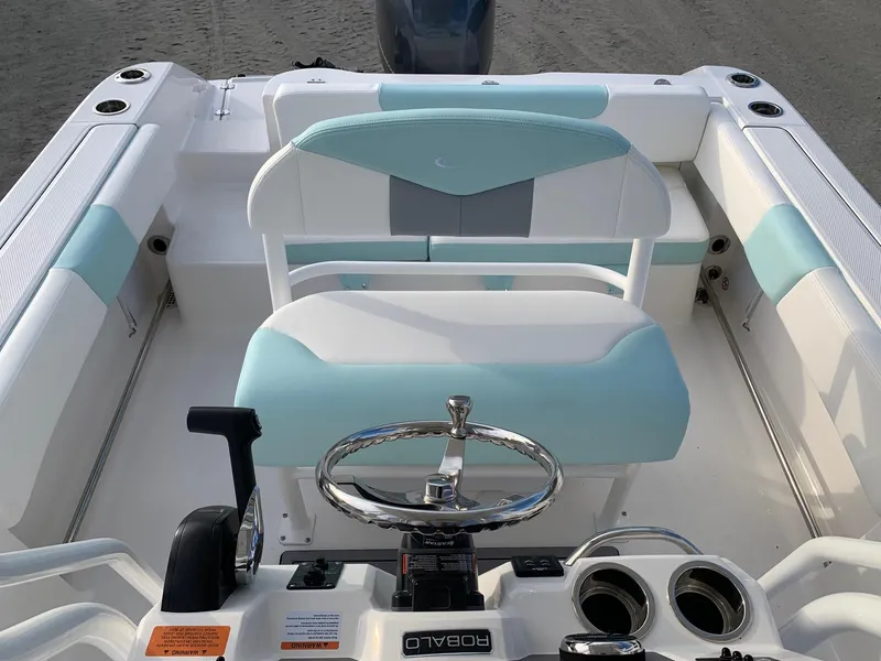 Slide: The Image of 2024 Robalo R202 Explorer boat interior with helm and seating. - 10