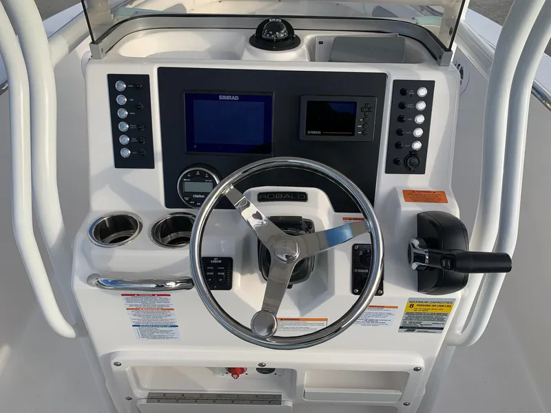 Slide: The Image of 2024 Robalo R202 Explorer boat console with steering wheel and navigation controls. - 8