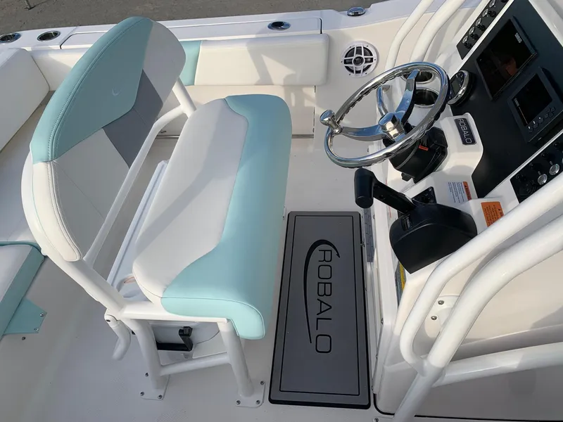 Slide: The Image of 2024 Robalo R202 Explorer boat cockpit with steering wheel and seating. - 9