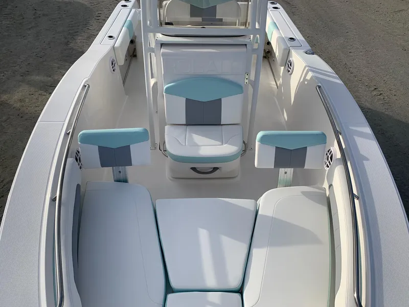 Slide: The Image of 2024 Robalo R202 Explorer boat interior with white and teal seating. - 12