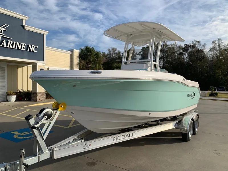 Slide: The Image of 2024 Robalo R202 Explorer boat on trailer outside Marine NC dealership. - 2