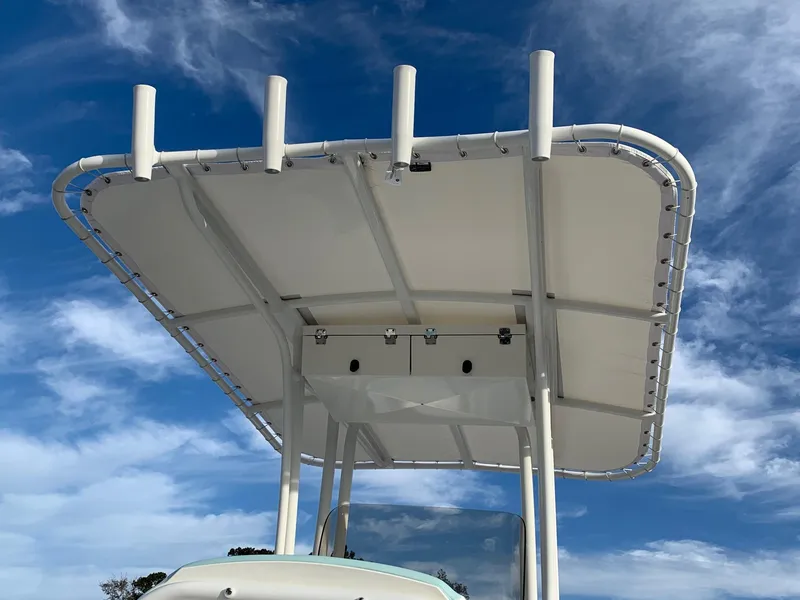 Slide: The Image of 2024 Robalo R202 Explorer boat T-top against blue sky. - 4