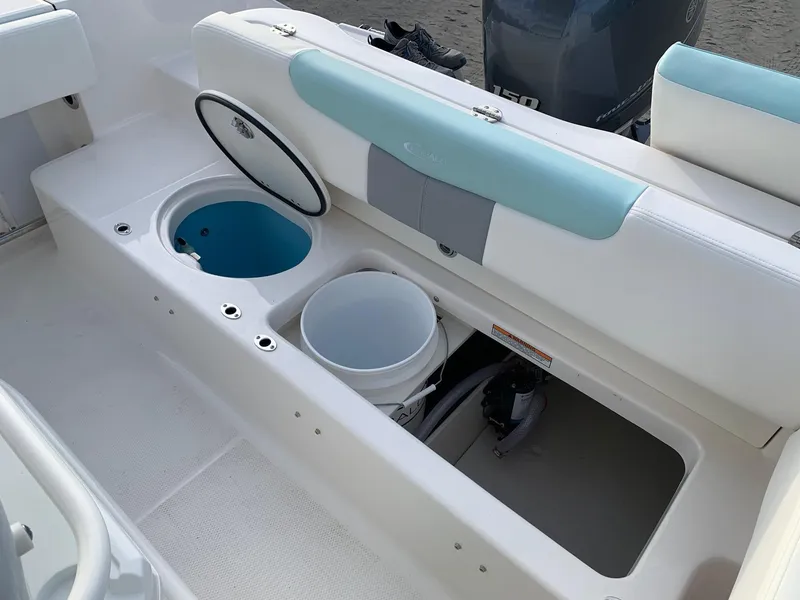Slide: The Image of 2024 Robalo R202 Explorer boat storage compartments and seating area. - 5