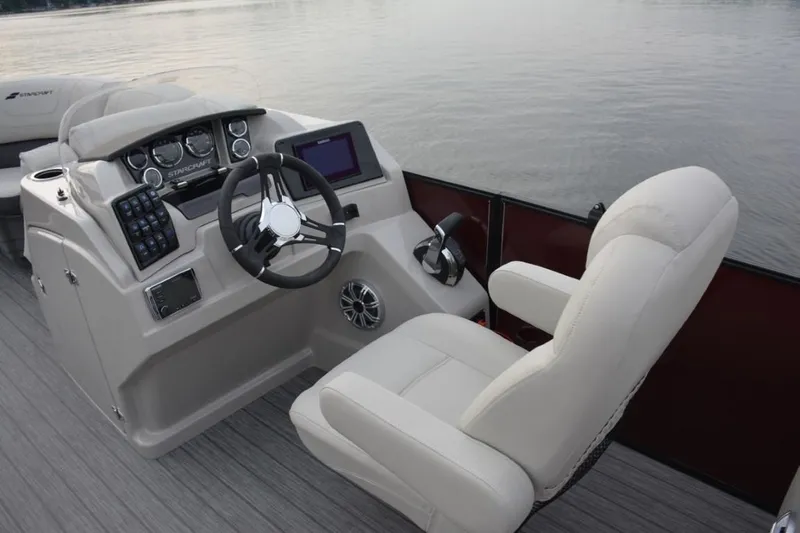 Slide: The Image of 2023 Starcraft SLS 3 boat helm with steering wheel and control panel. - 12