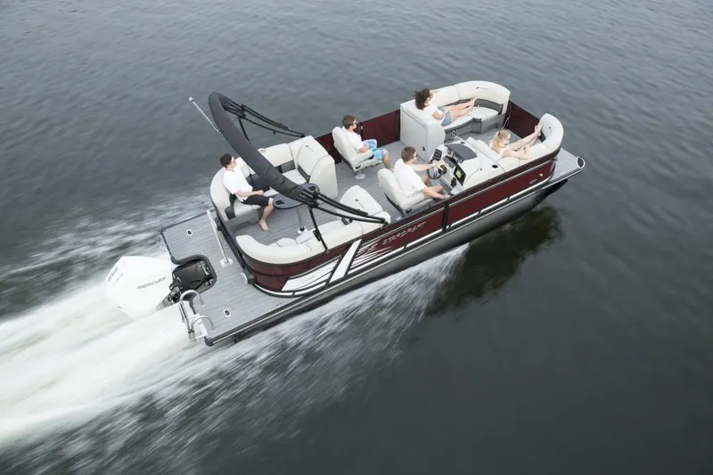 Slide: The Image of 2023 Starcraft SLS 3 pontoon boat cruising on water with passengers. - 2