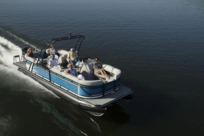 Slide: The Image of 2023 Starcraft SLS 3 pontoon boat cruising on a lake with passengers. - 4