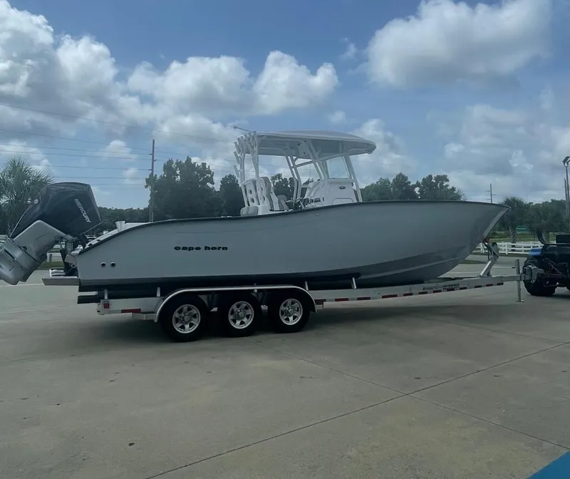 Slide: The Image of 2024 Cape Horn 31T boat on a trailer under a cloudy sky. - 2