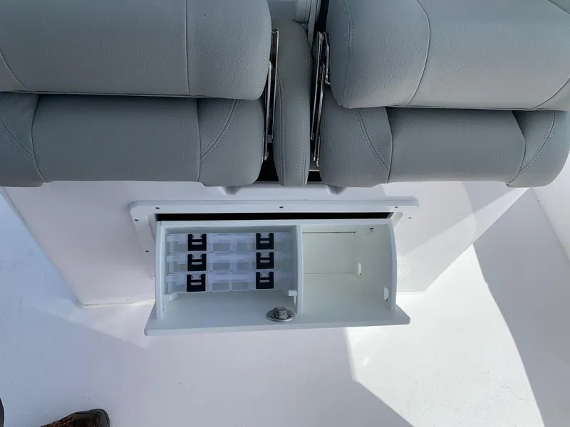 Slide: The Image of 2024 Cape Horn 31T boat storage compartment with gray cushioned seats. - 9