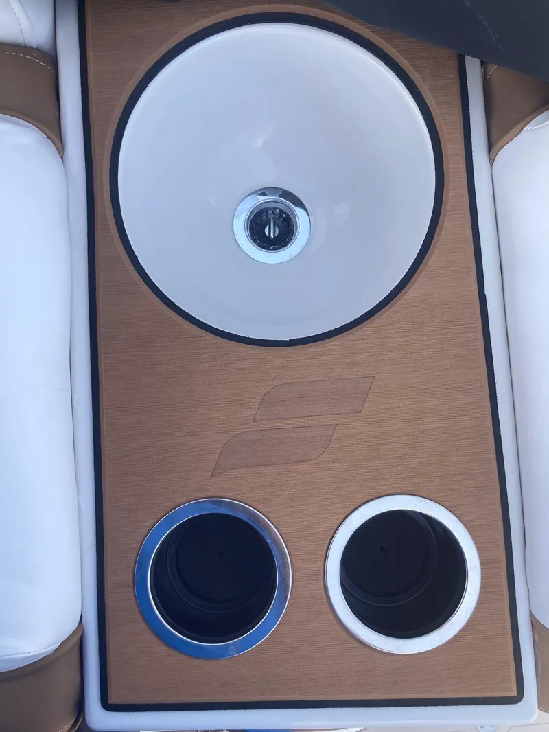 Slide: The Image of 2024 Starcraft SVX 191 boat console with cup holders and sink. - 7