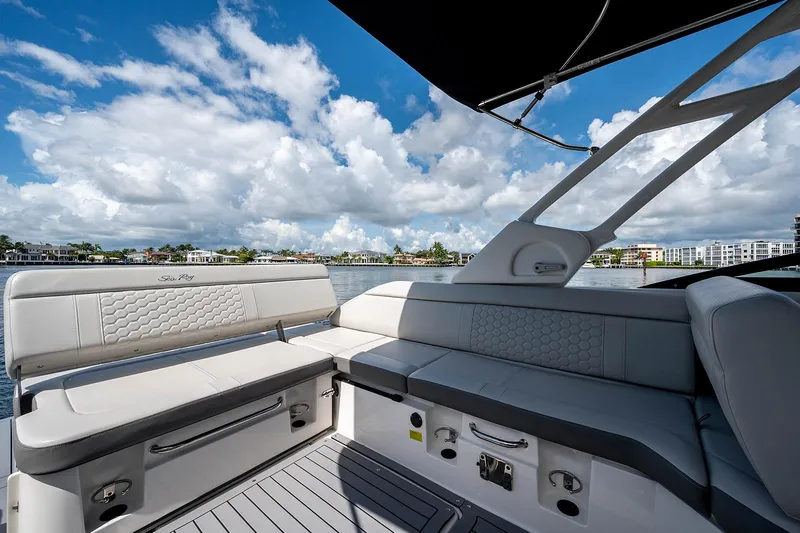 Slide: The Image of 2021 Sea Ray 25 SDX boat interior with luxurious seating and scenic waterfront view. - 15