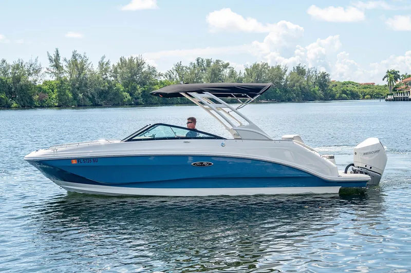 Slide: The Image of 2021 Sea Ray 25 SDX boat cruising on a calm lake. - 2
