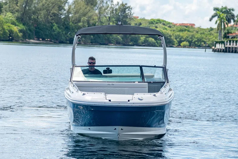 Slide: The Image of 2021 Sea Ray 25 SDX boat cruising on a calm lake. - 3