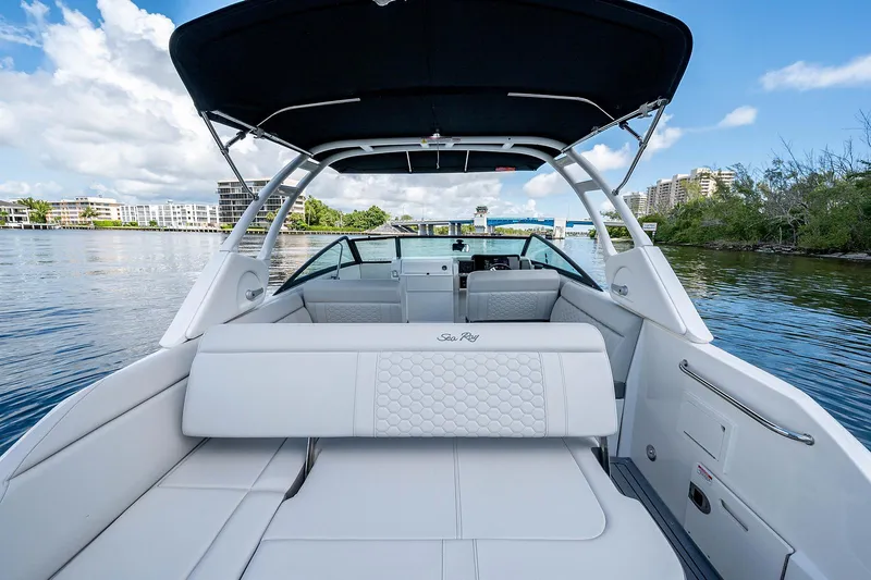 Slide: The Image of 2021 Sea Ray 25 SDX boat interior with white seating and black canopy. - 7