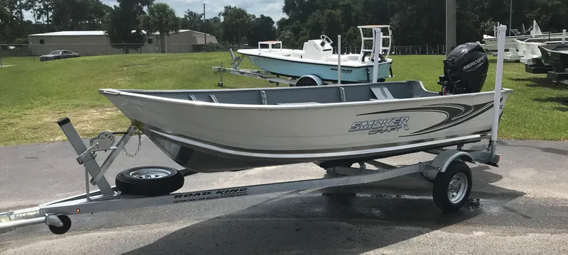 Slide: The Image of 2021 Smoker Craft Alaskan TL SSDLX boat on trailer, parked outdoors. - 0