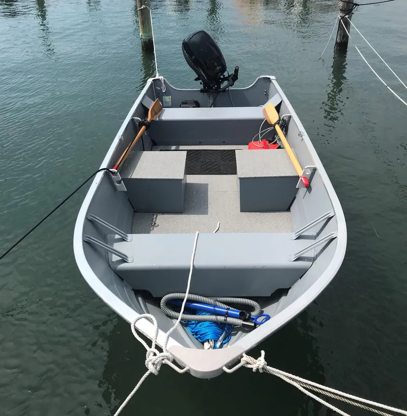 Slide: The Image of 2021 Smoker Craft Alaskan TL SSDLX boat docked on calm water. - 1
