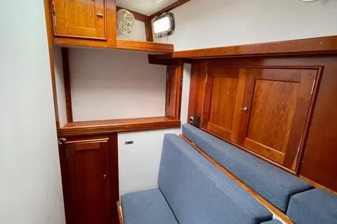 Slide: The Image of Interior of 2014 Shannon 55 HPS yacht with wooden cabinets and blue seating. - 19