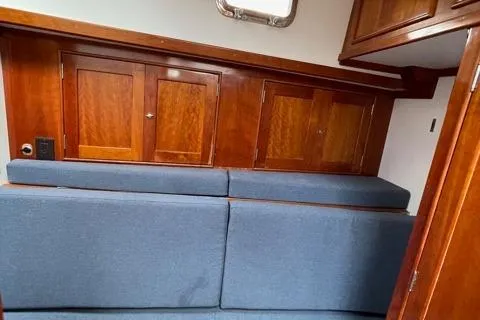 Slide: The Image of Interior of 2014 Shannon 55 HPS yacht with blue seating and wooden cabinets. - 20