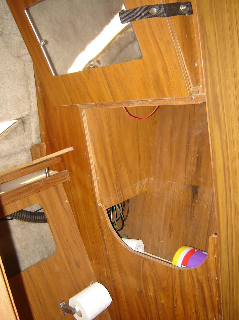 Slide: The Image of Interior of a 1980 Century 26 boat with wooden cabinetry and storage compartments. - 34