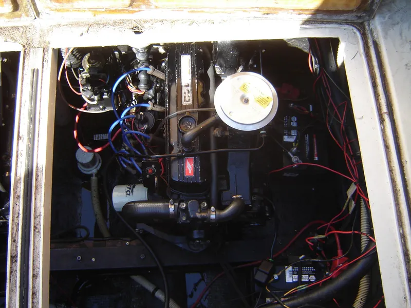 Slide: The Image of Engine compartment of a 1980 Century 26 boat with visible wiring and components. - 35