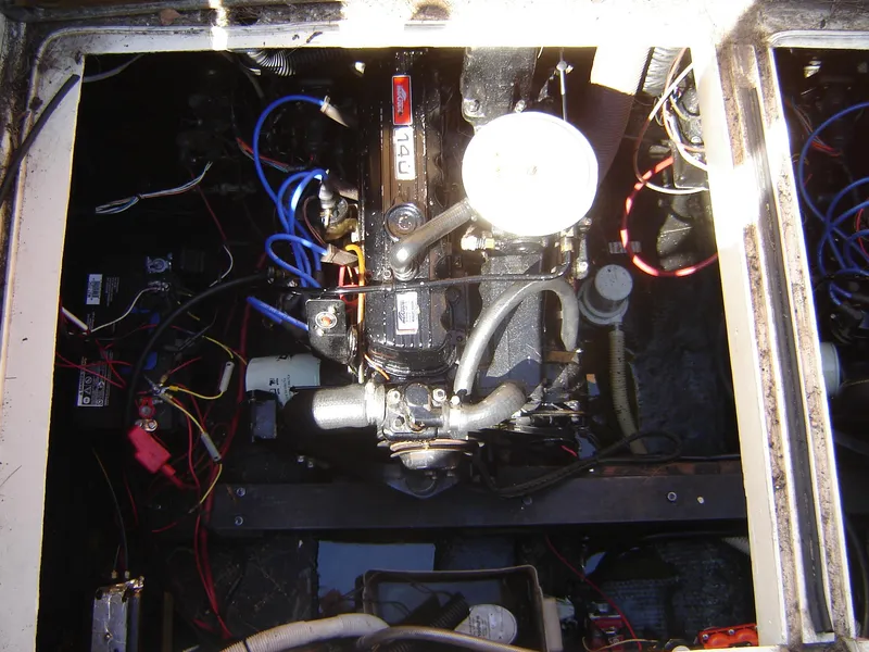 Slide: The Image of Engine compartment of a 1980 Century 26 boat with visible wiring and components. - 36