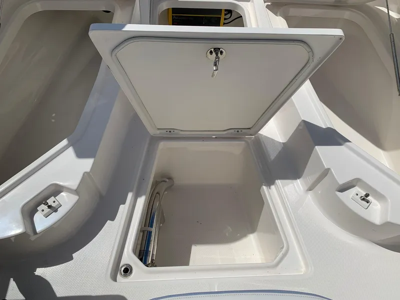 Slide: The Image of 2024 Robalo 266 Cayman storage compartment with open hatch. - 17