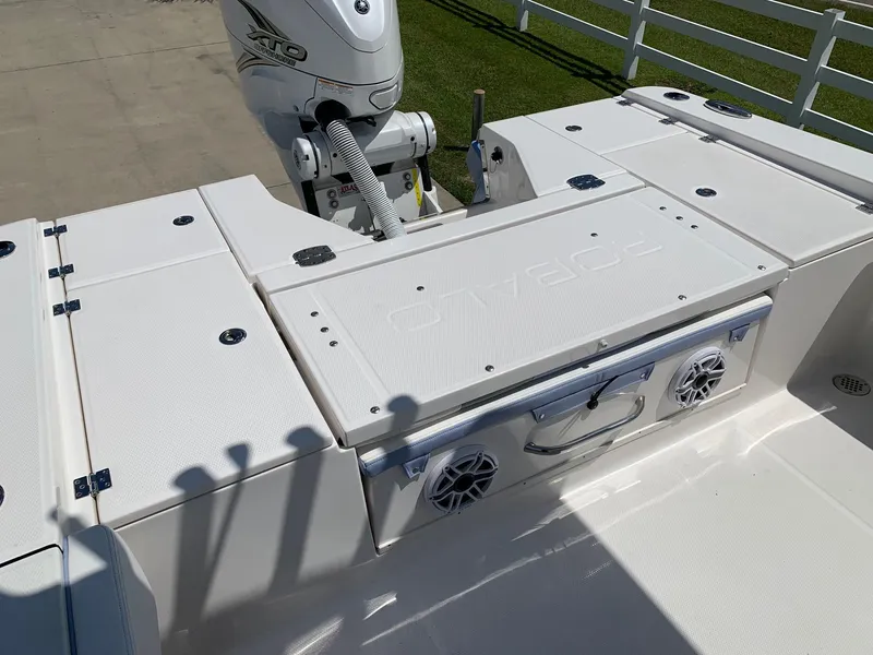 Slide: The Image of 2024 Robalo 266 Cayman boat deck with storage compartments and motor. - 10