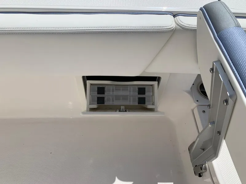 Slide: The Image of 2024 Robalo 266 Cayman storage compartment with cushioned seating. - 14