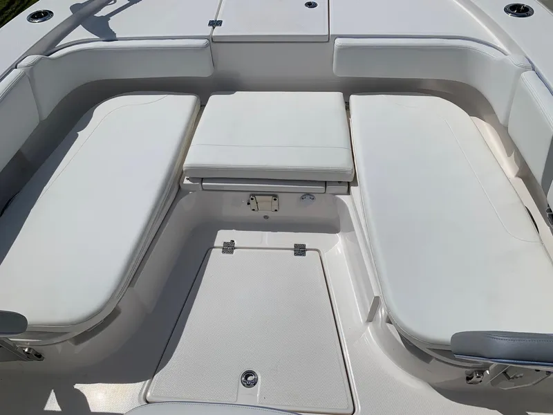 Slide: The Image of 2024 Robalo 266 Cayman boat interior seating area with white cushions. - 18