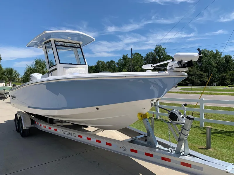 Slide: The Image of 2024 Robalo 266 Cayman boat on a trailer, ready for transport. - 2