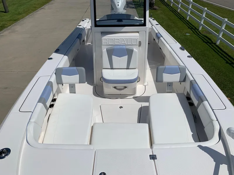 Slide: The Image of 2024 Robalo 266 Cayman boat interior with white seating and console. - 6