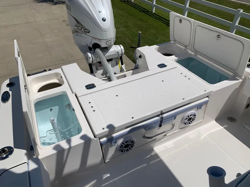 Slide: The Image of 2024 Robalo 266 Cayman boat deck with storage compartments and outboard motor. - 7