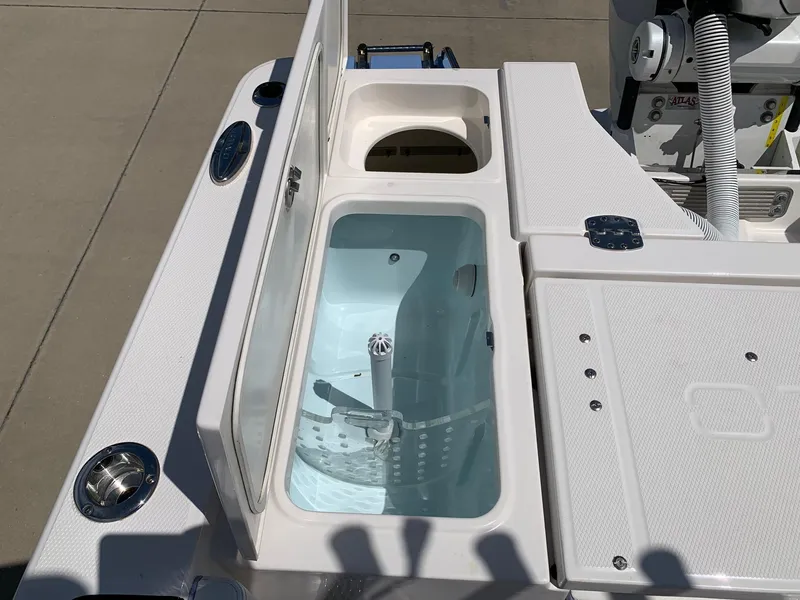 Slide: The Image of 2024 Robalo 266 Cayman boat livewell and storage compartments. - 8