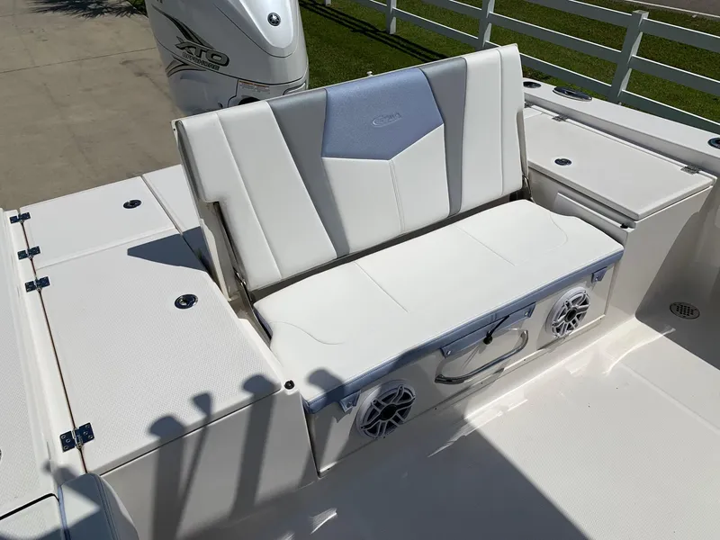 Slide: The Image of 2024 Robalo 266 Cayman boat seating area with storage and speakers. - 9