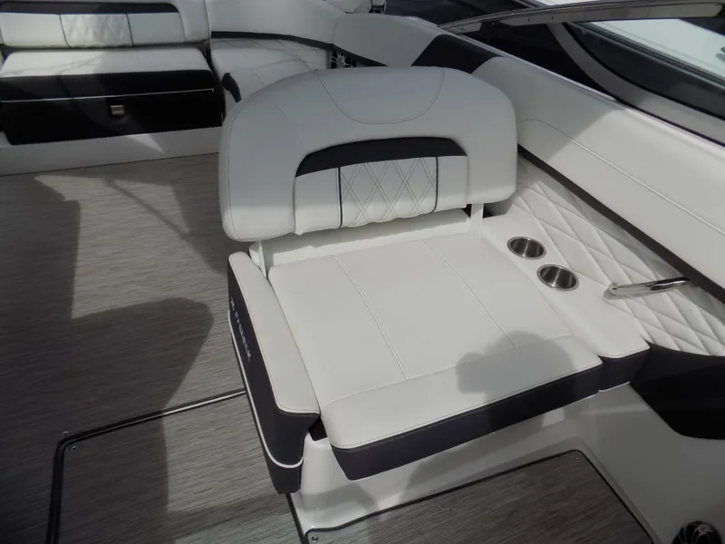 Slide: The Image of 2019 Regal 26 FasDeck boat interior with white seating and cup holders. - 10