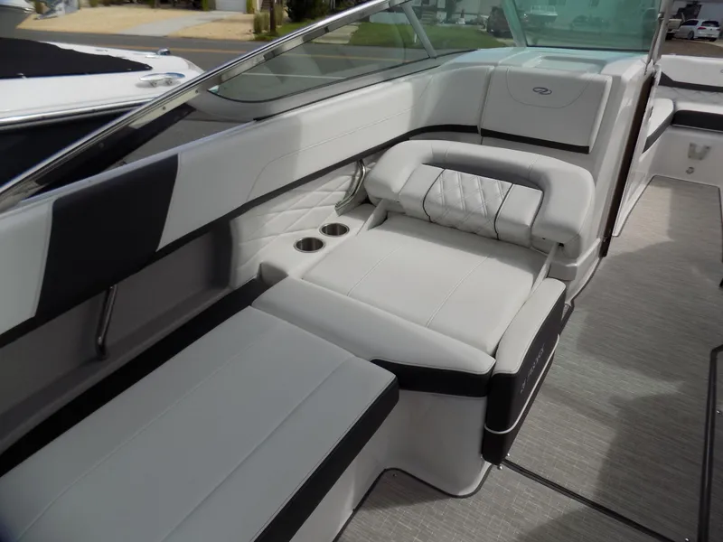 Slide: The Image of 2019 Regal 26 FasDeck boat interior with white and black seating, cup holders, and sleek design. - 11