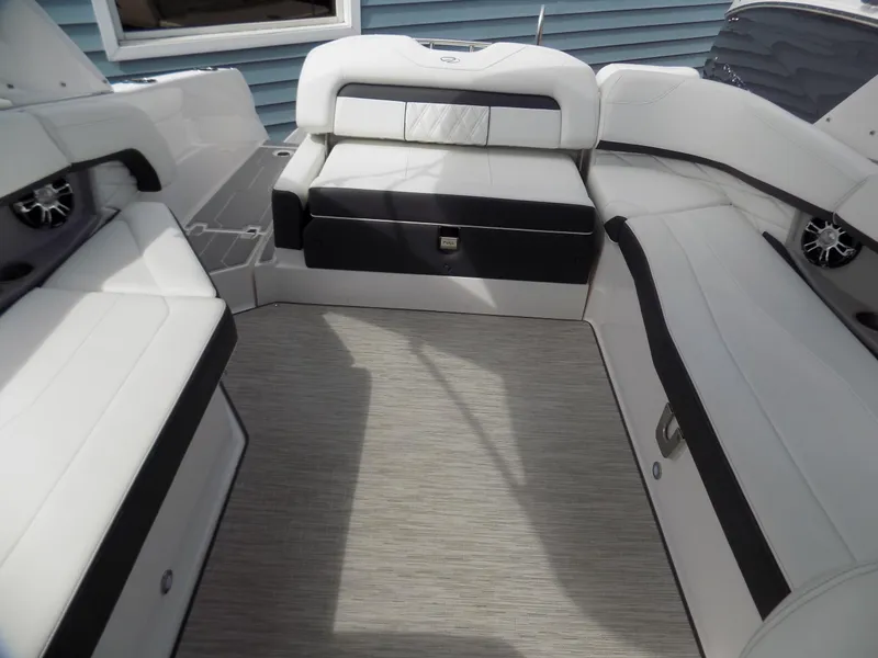 Slide: The Image of 2019 Regal 26 FasDeck boat interior with white and black seating, spacious layout. - 12