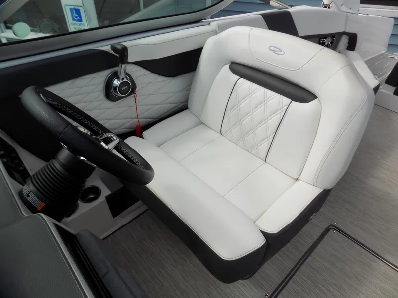 Slide: The Image of 2019 Regal 26 FasDeck boat interior with white leather seating and steering wheel. - 6