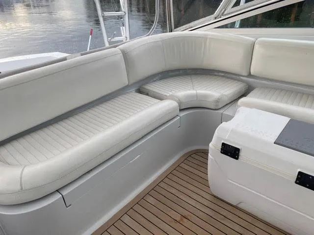 Slide: The Image of 2003 Viking 50 Open boat with white cushioned seating and teak flooring. - 12
