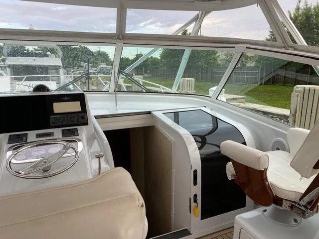 Slide: The Image of 2003 Viking 50 Open yacht helm with white seating and navigation controls. - 14