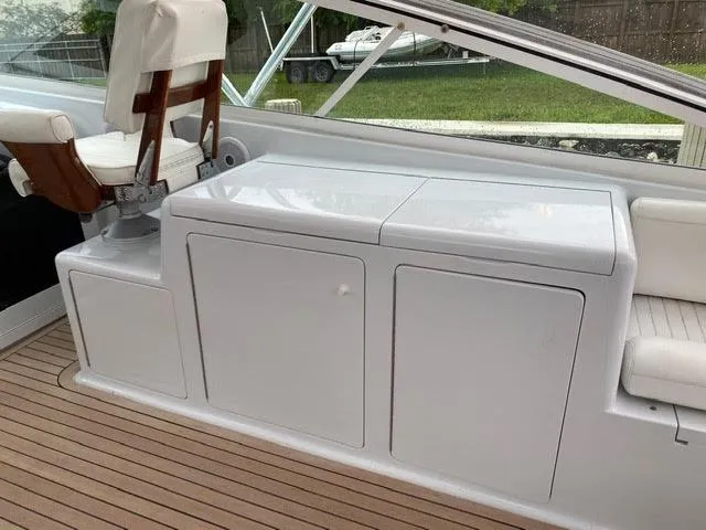 Slide: The Image of 2003 Viking 50 Open boat interior with white seating and storage compartments. - 15