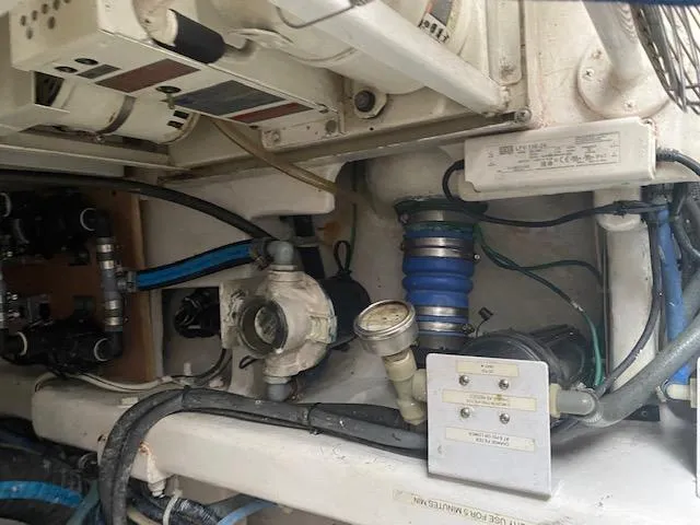 Slide: The Image of Engine compartment of a 2003 Viking 50 Open boat showing various mechanical components. - 19