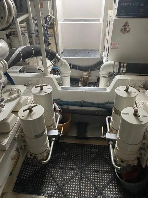 Slide: The Image of Engine room of a 2003 Viking 50 Open yacht with visible fuel filters and piping. - 20