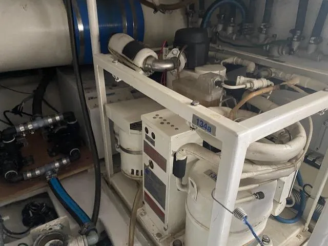 Slide: The Image of Engine room of a 2003 Viking 50 Open yacht showing machinery and piping. - 21