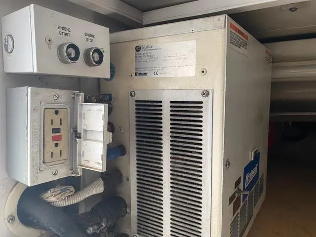 Slide: The Image of Electrical panel and generator inside a 2003 Viking 50 Open boat. - 22