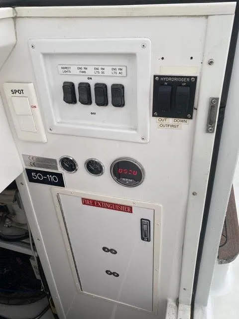 Slide: The Image of Control panel of a 2003 Viking 50 Open boat with various switches and gauges. - 24