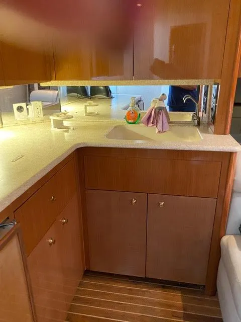 Slide: The Image of 2003 Viking 50 Open yacht kitchen with wooden cabinets and countertop. - 28