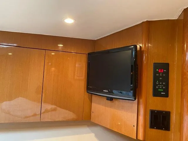 Slide: The Image of Flat-screen TV and control panel in 2003 Viking 50 Open yacht interior. - 29