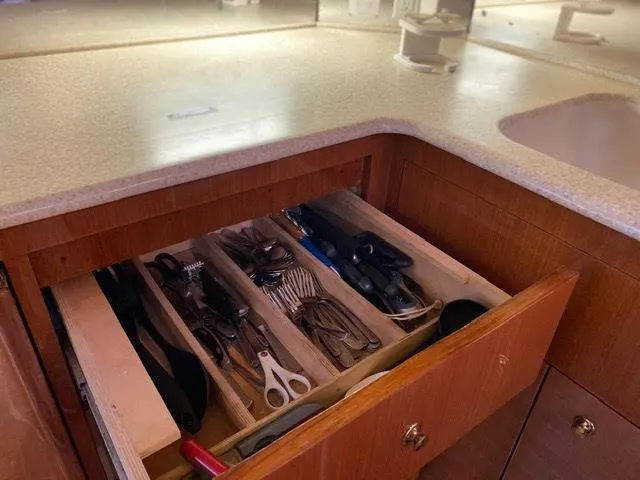 Slide: The Image of Open drawer with utensils in the kitchen of a 2003 Viking 50 Open yacht. - 30